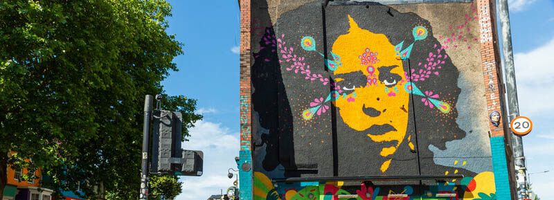 a mural of a woman on the side of a building in Stokes Croft